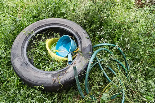 messy yard with tire keep mosquitoes away